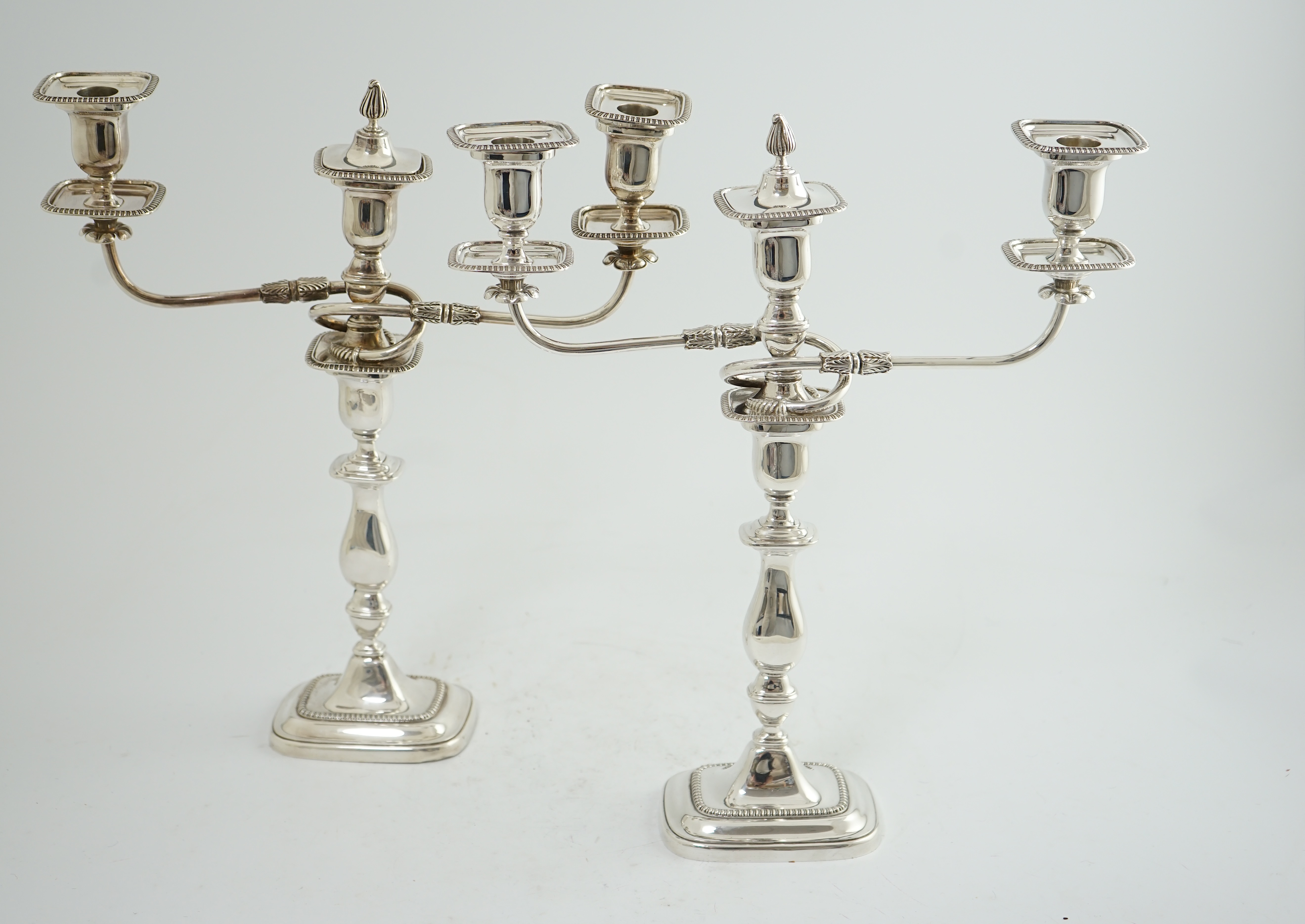 A pair of Elizabeth II silver two branch two light candelabra, by James Dixon & Sons